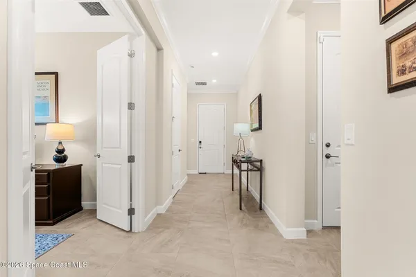 a view of a hallway with closet and a bathroom