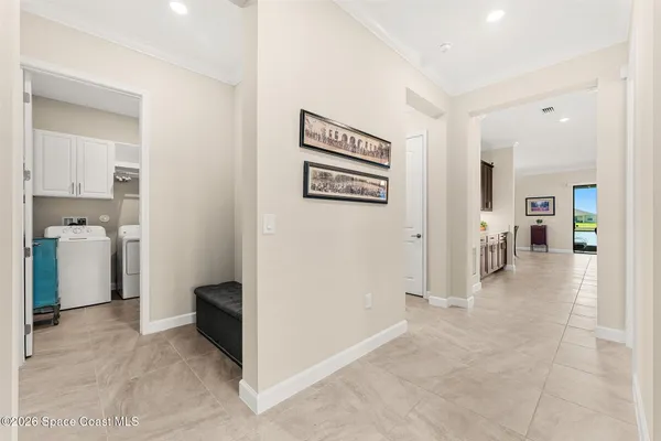 a view of a hallway with bathroom and a area