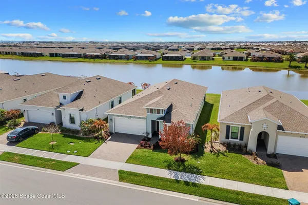 an aerial view of a house with a ocean view