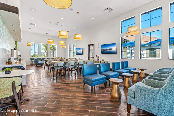 a view of a dining room with furniture and chandelier