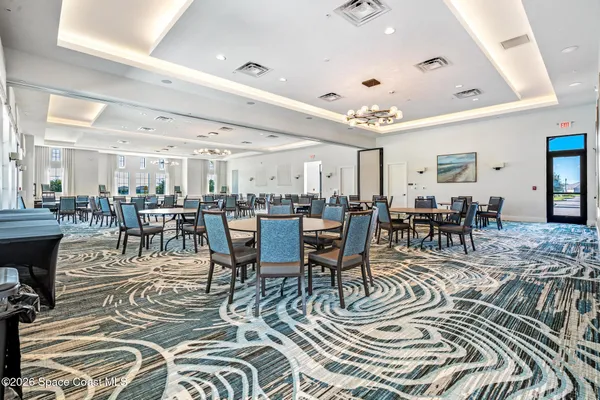 a room with table chairs and entryway