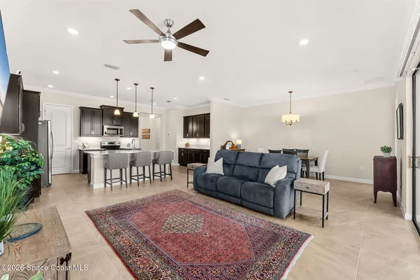 a living room with furniture and kitchen view