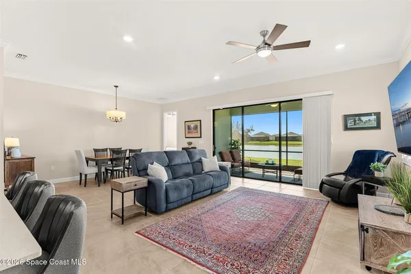 a living room with furniture ceiling fan and a rug