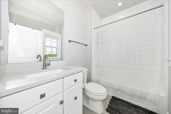 a bathroom with a toilet a sink and a mirror