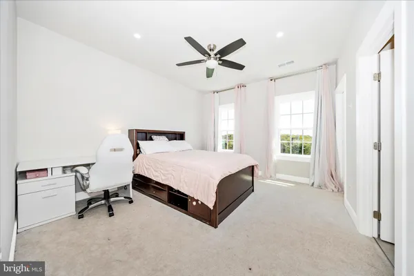a view of a livingroom with furniture and windows in a room