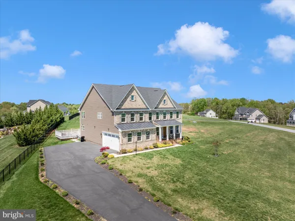 a front view of a house with a garden and yard