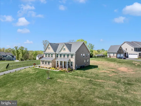 a view of backyard of house with green space