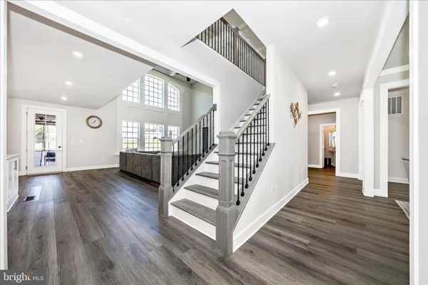 a living room with furniture wooden floor and a large window