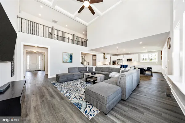 a large kitchen with cabinets wooden floor and stainless steel appliances