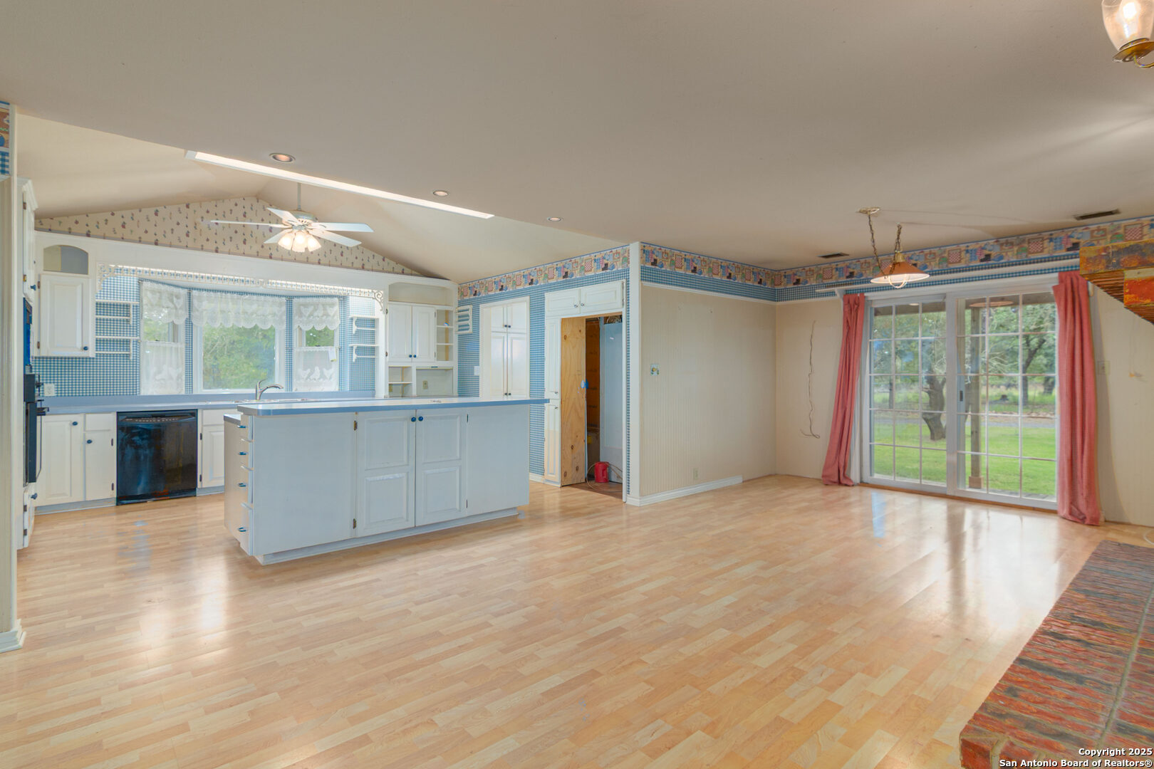 2981 Vivroux Ranch Road Seguin, TX 78155 - Photo 29 of 50 a view of an empty room with wooden floor and a kitchen