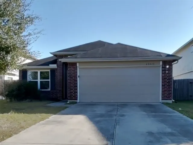 a front view of house with a garden