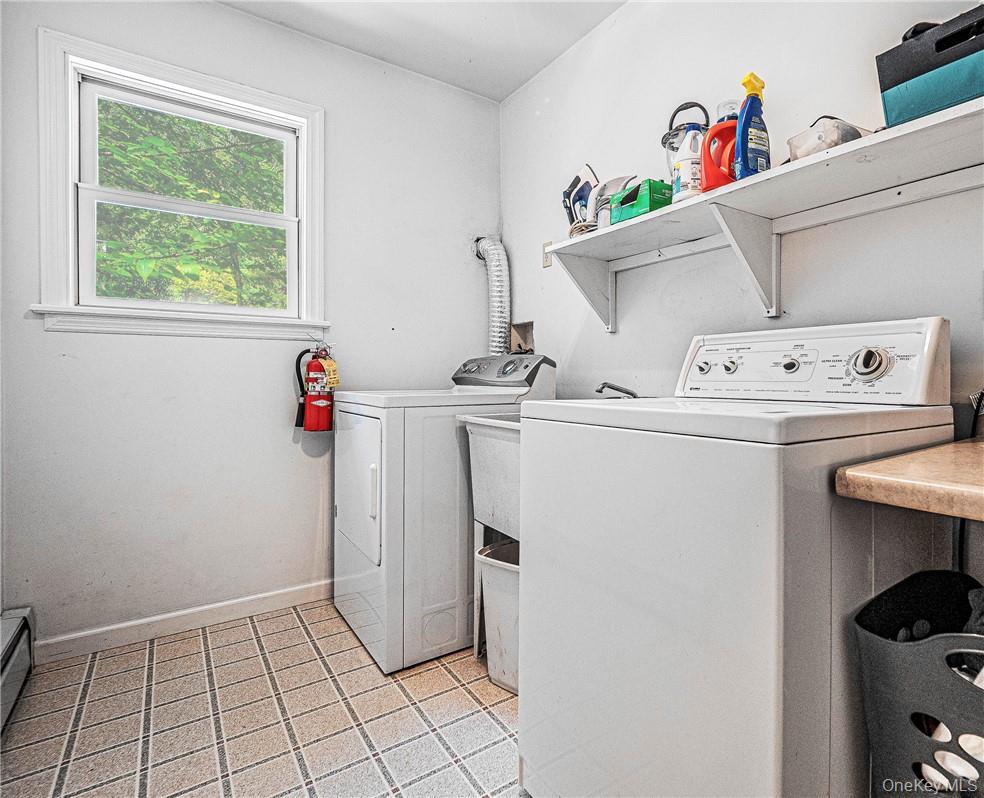 20 Rustic Hills Road Wurtsboro, NY 12790 - Photo 12 of 25 Nice size laundry room with a soap sink, a counter to fold your clothes, and a shelf to store other items that are easy to grab for your laundry needs.