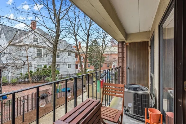 a view of a balcony with wooden floor and fence