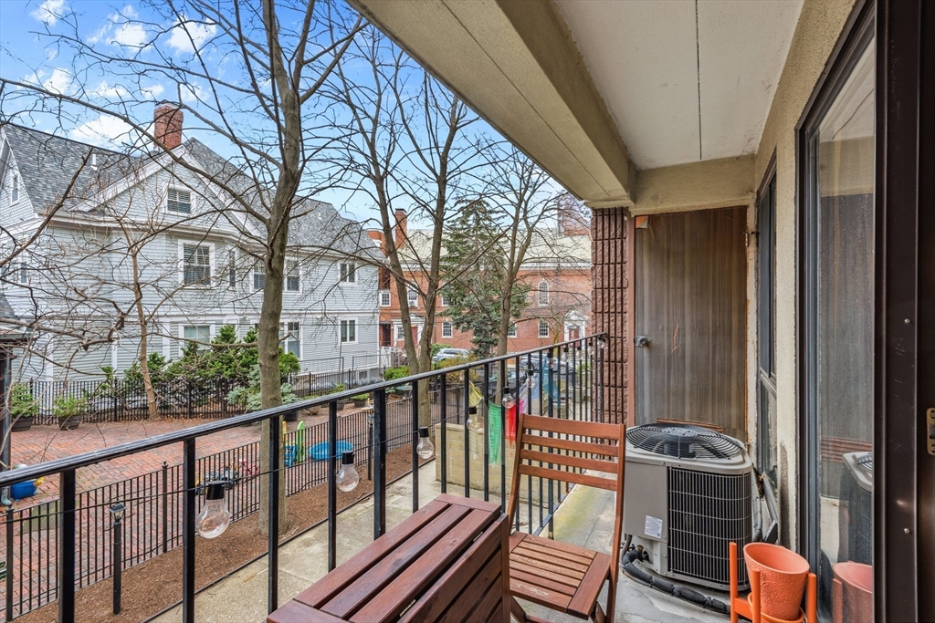 55 Sewall Avenue, Unit 1C Brookline, MA 02446 - Photo 14 of 16 a view of a balcony with wooden floor and fence