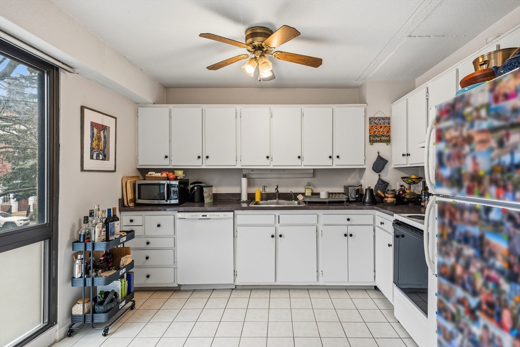 55 Sewall Avenue, Unit 1C Brookline, MA 02446 - Photo 5 of 16 a kitchen with stainless steel appliances a stove a sink and a refrigerator