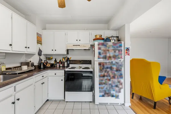 a kitchen with stainless steel appliances granite countertop a sink a stove a refrigerator and cabinets