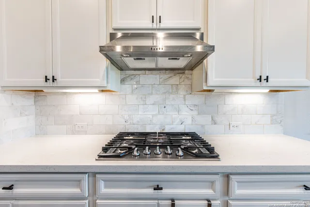 a stove top oven sitting inside of a kitchen
