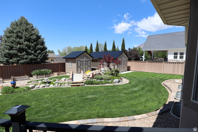 1055 North 1000 East Mapleton, UT 84664 - Photo 75 of 112 Expansive backyard featuring a manicured lawn, terraced rock gardens, and a built-in play structure