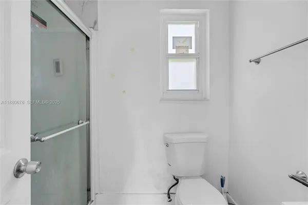 a white toilet sitting next to a bathroom sink