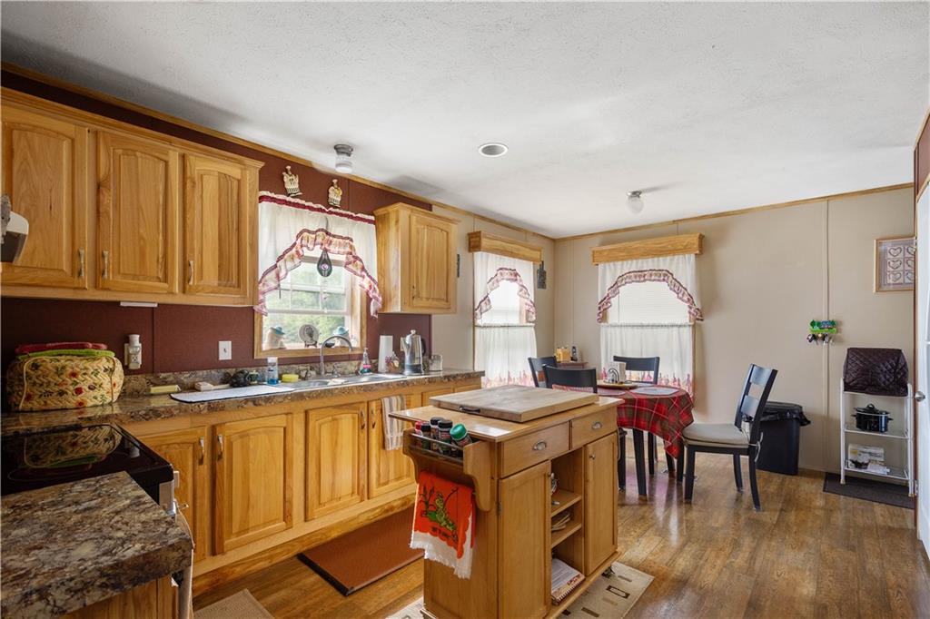 534 Finks Run Road McDonald, PA 15057 - Photo 27 of 35 a open kitchen with stainless steel appliances granite countertop a stove top oven a sink dishwasher and cabinets with wooden floor