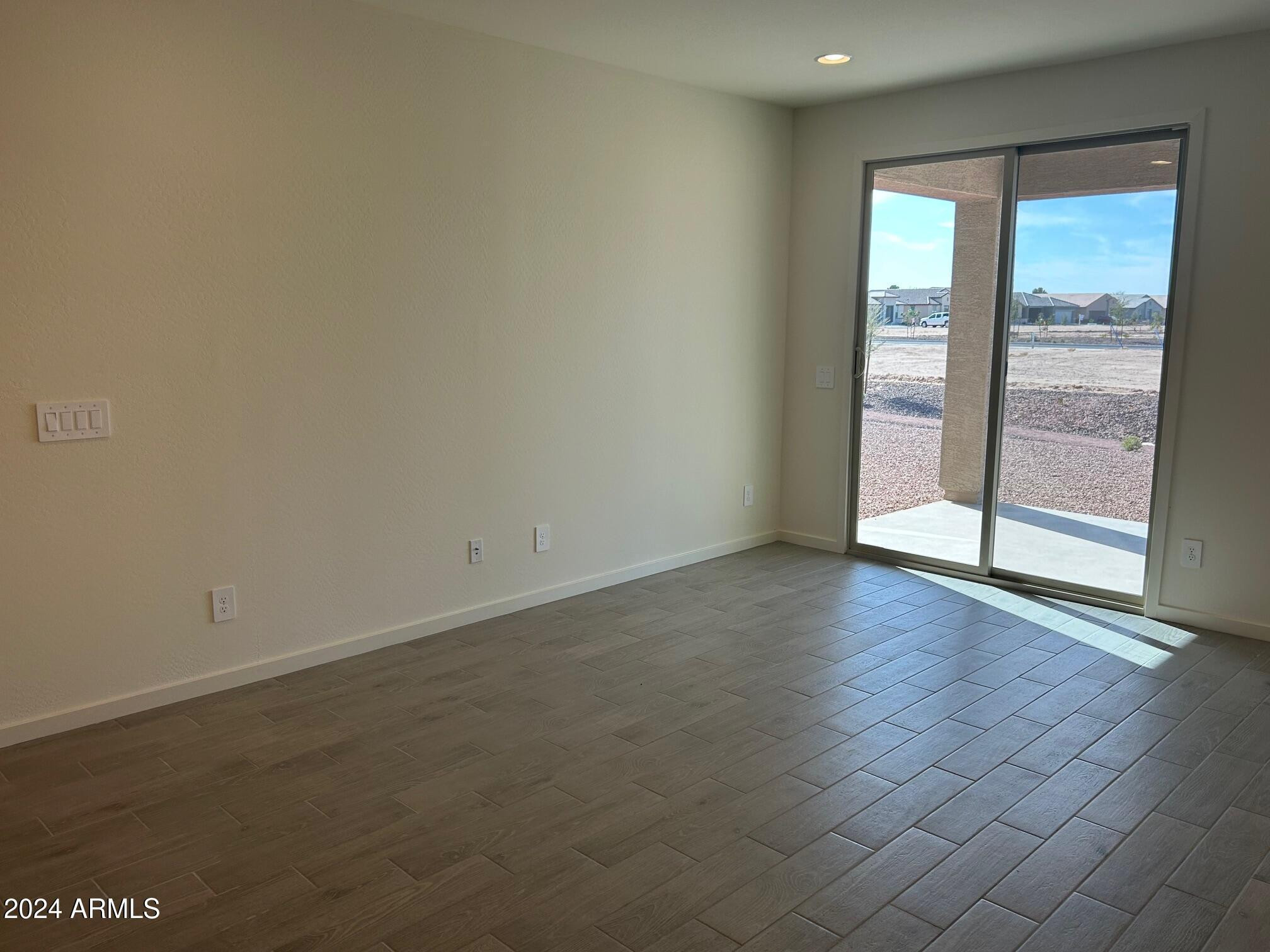 20520 North Candlelight Road Maricopa, AZ 85138 - Photo 8 of 18 an empty room with wooden floor and windows