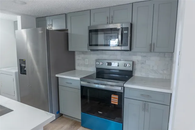 a kitchen with a stove and a microwave