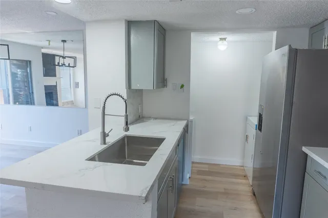 a kitchen with a sink and a refrigerator