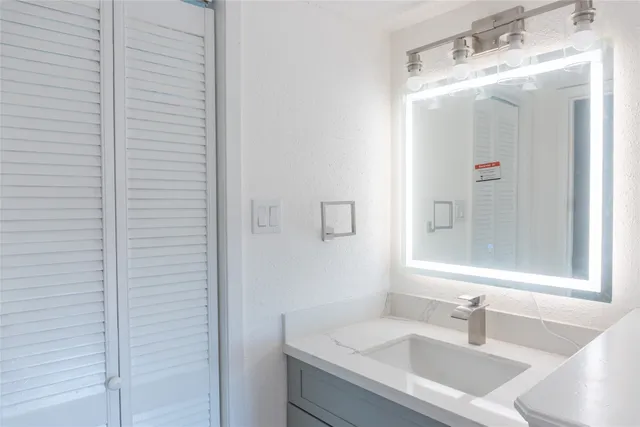 a bathroom with a sink and a mirror
