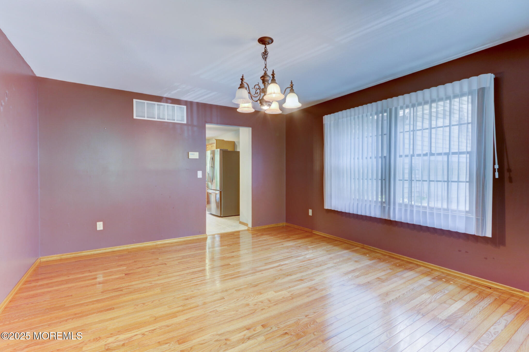 143 Siloam Road Freehold, NJ 07728 - Photo 19 of 55 a view of an empty room with wooden floor and a window