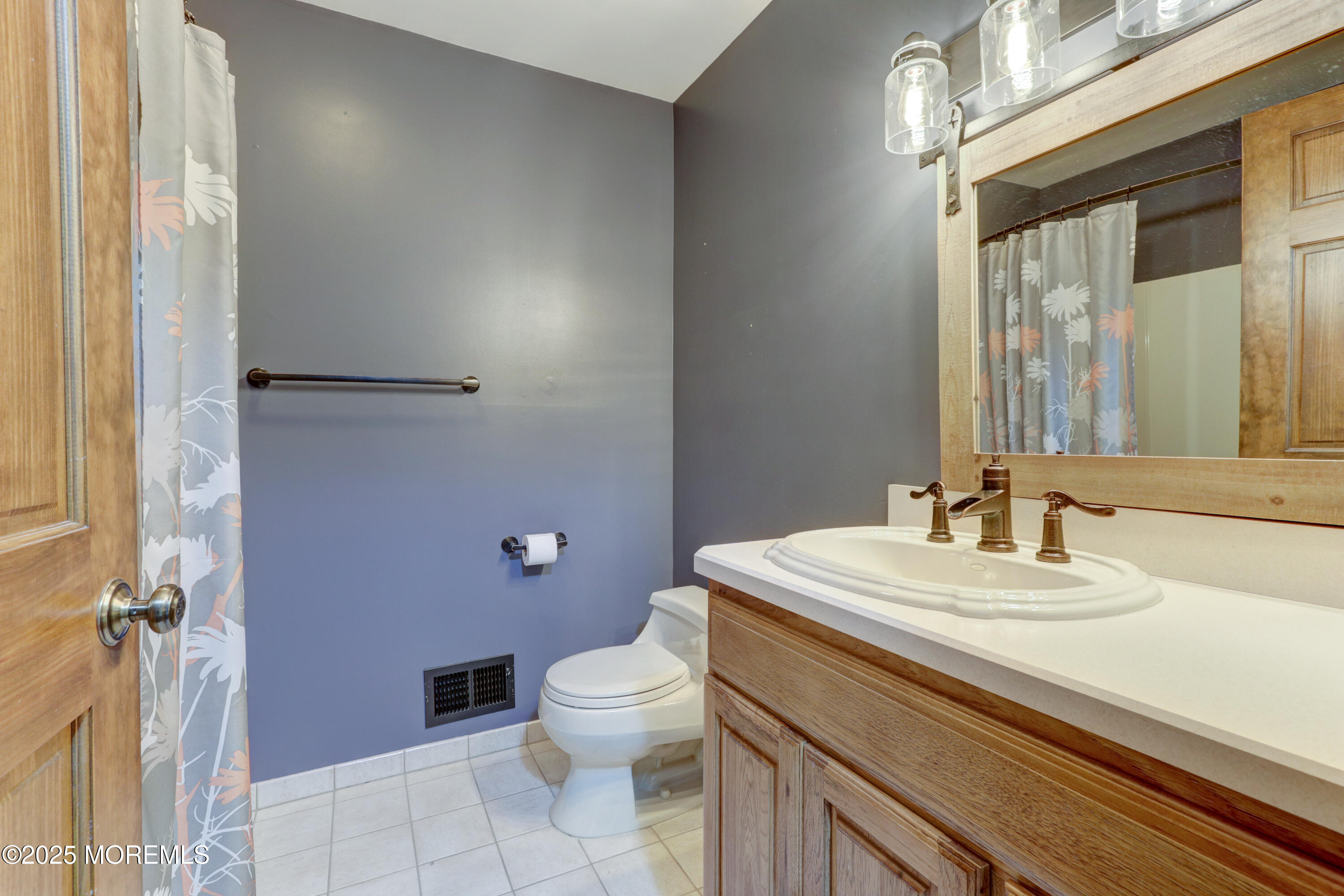 143 Siloam Road Freehold, NJ 07728 - Photo 28 of 55 a bathroom with a sink a toilet a mirror and vanity