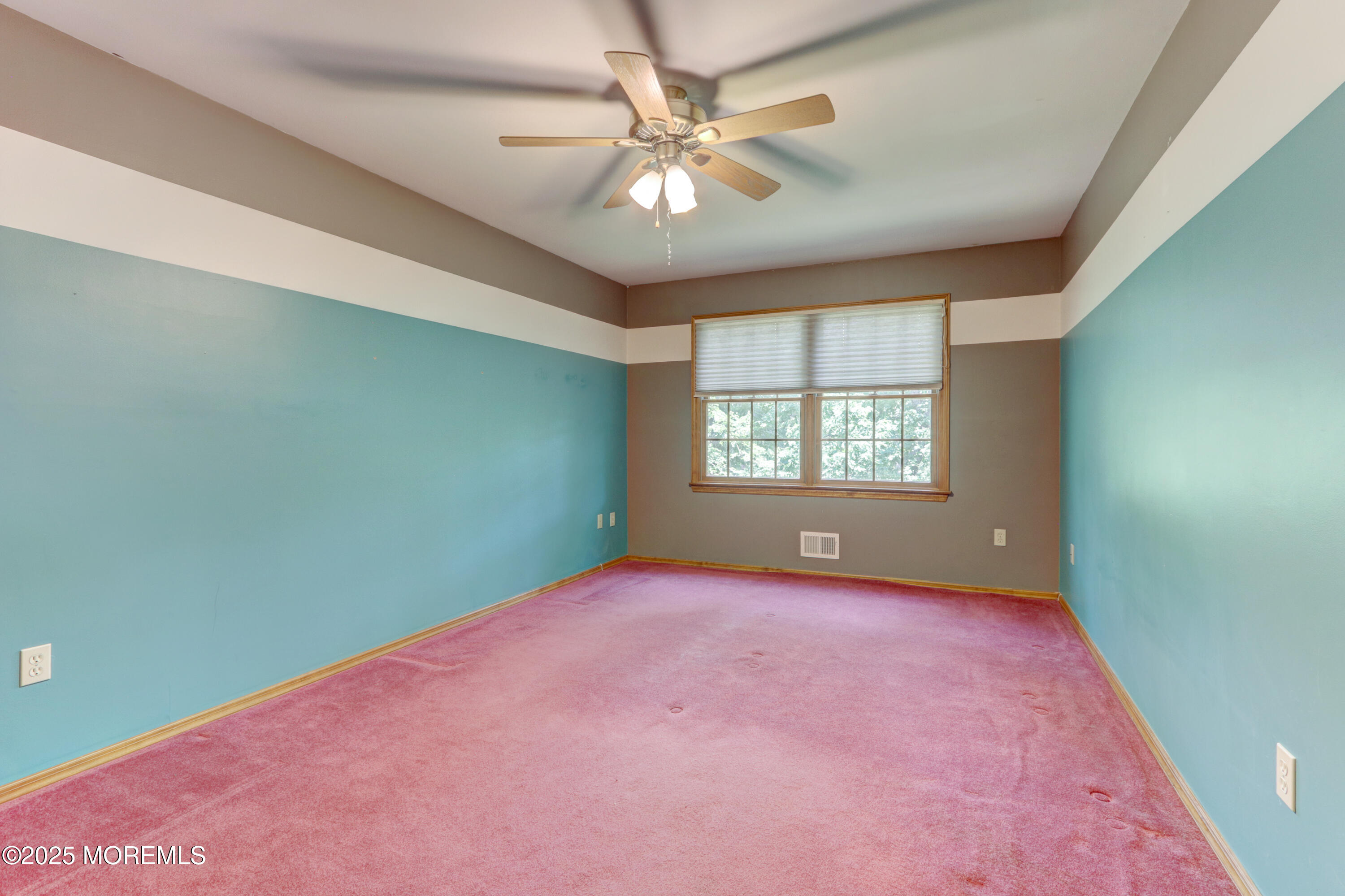 143 Siloam Road Freehold, NJ 07728 - Photo 29 of 55 an empty room with windows and ceiling fan