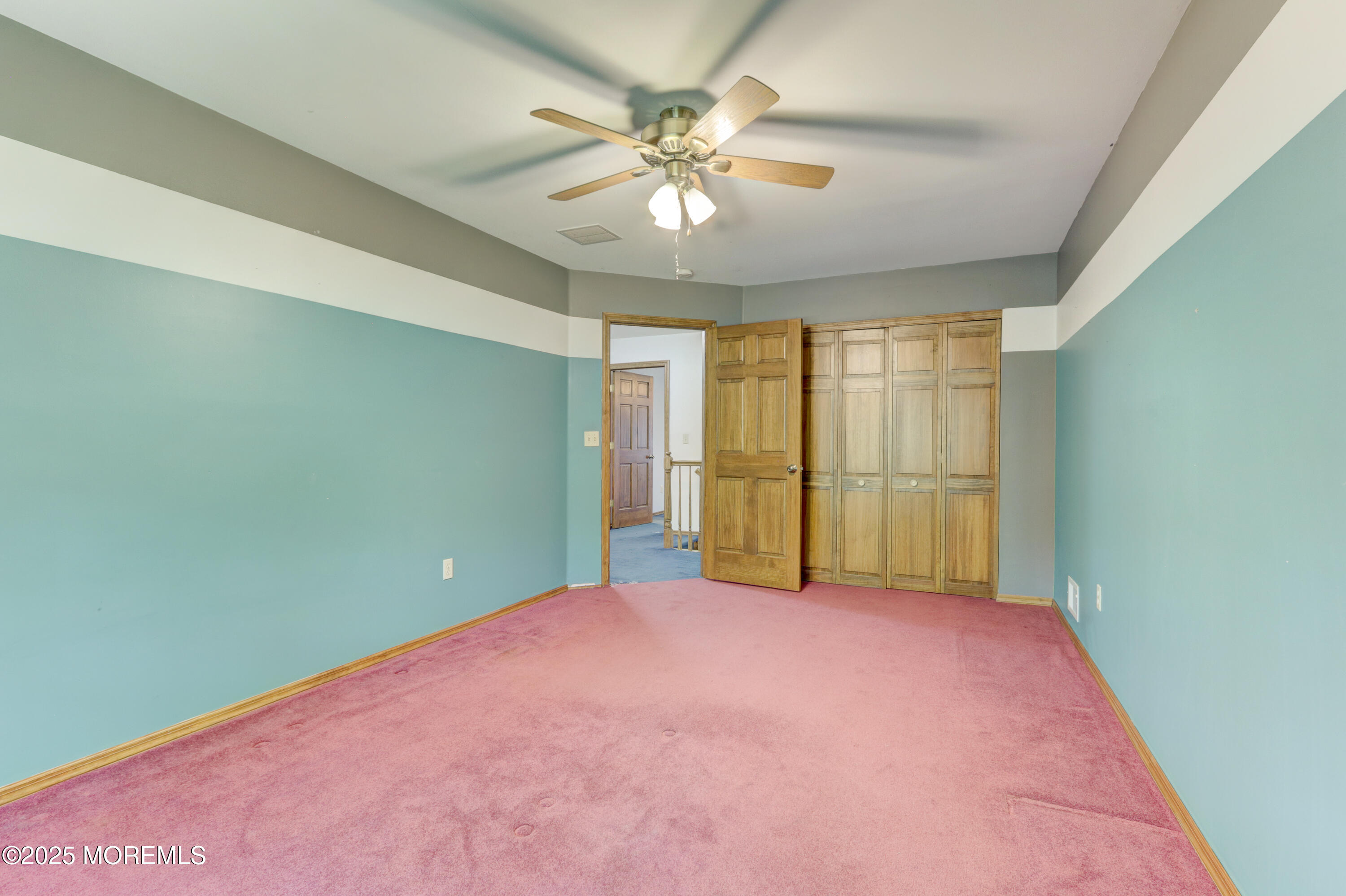 143 Siloam Road Freehold, NJ 07728 - Photo 30 of 55 an empty room with windows and ceiling fan