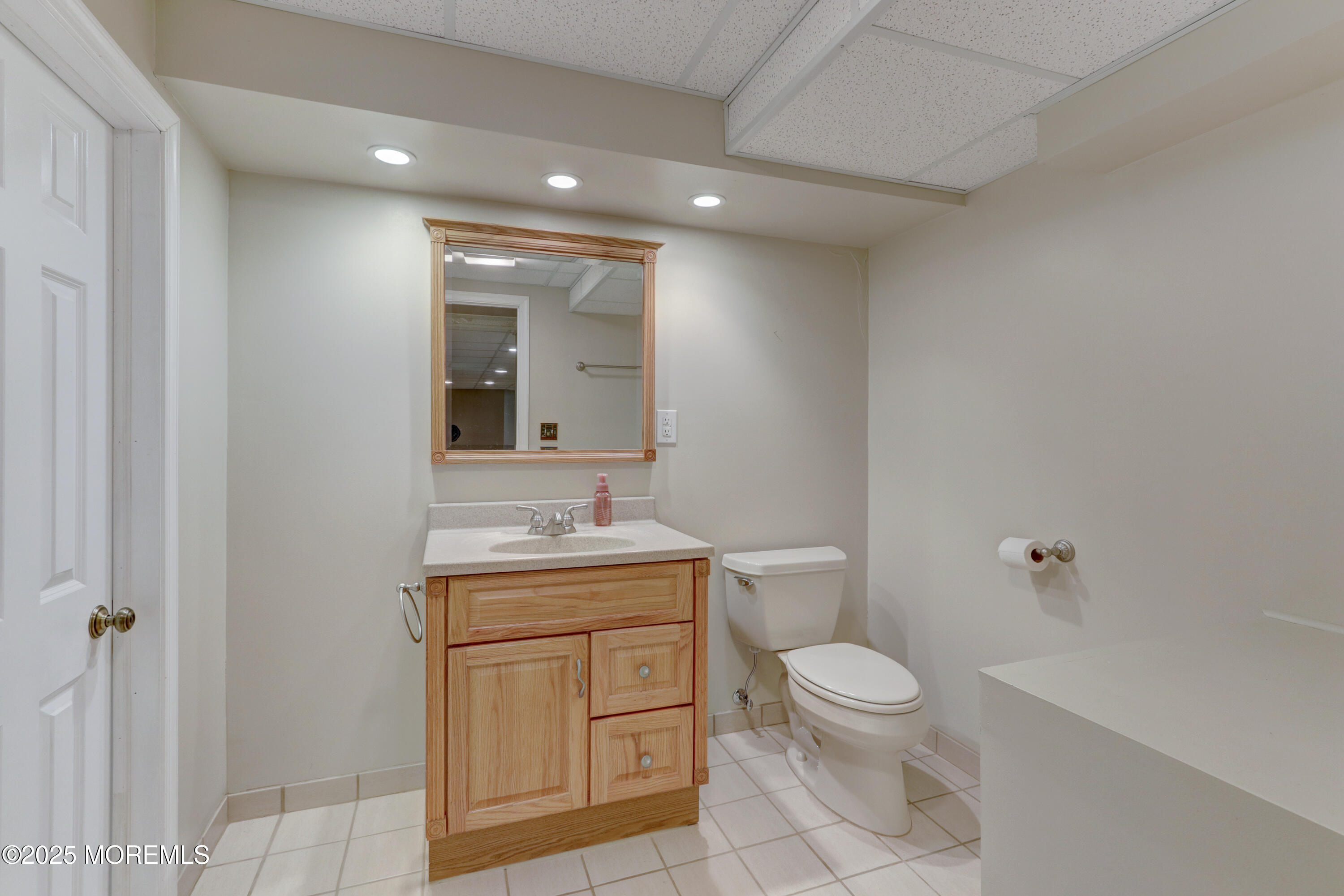 143 Siloam Road Freehold, NJ 07728 - Photo 37 of 55 a bathroom with a toilet a sink and mirror