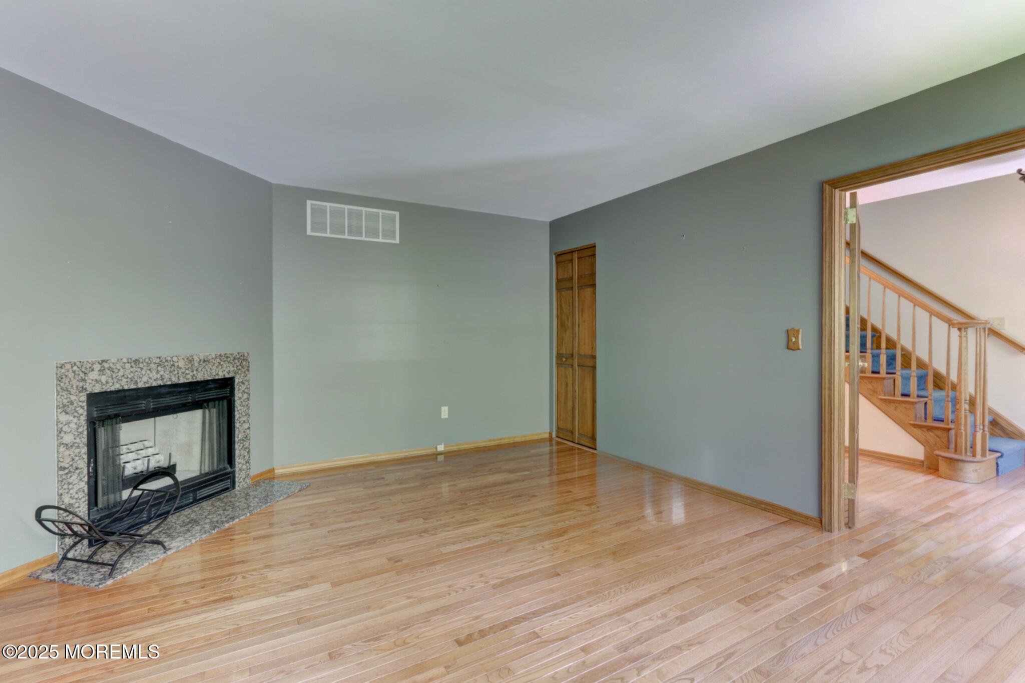 143 Siloam Road Freehold, NJ 07728 - Photo 6 of 55 a view of an empty room with wooden floor and a fireplace