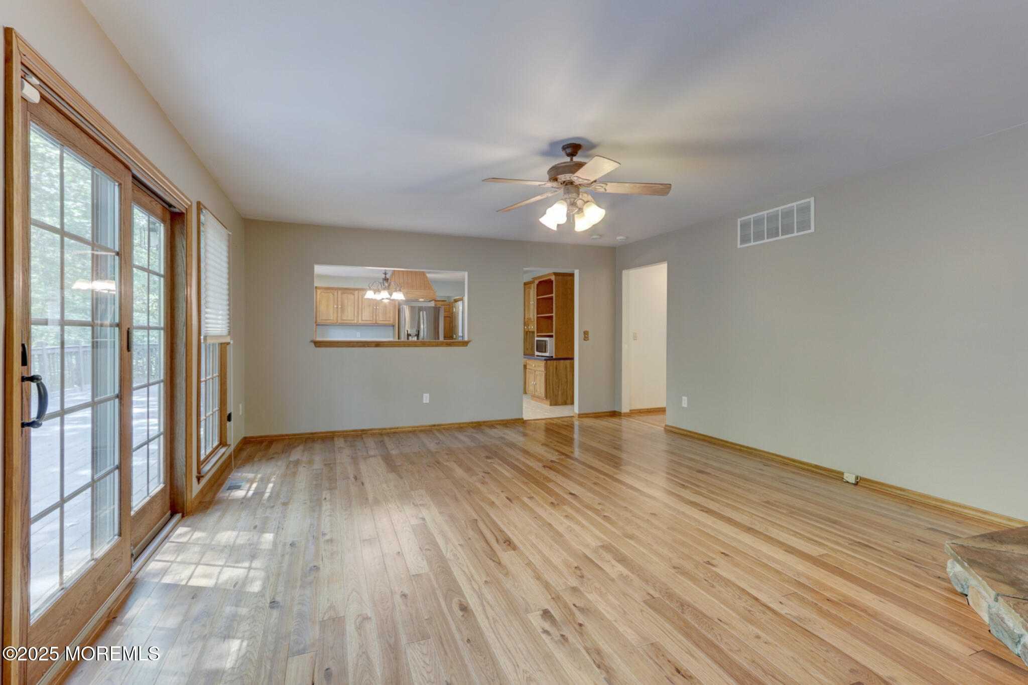 143 Siloam Road Freehold, NJ 07728 - Photo 10 of 55 a view of an empty room with a window and wooden floor