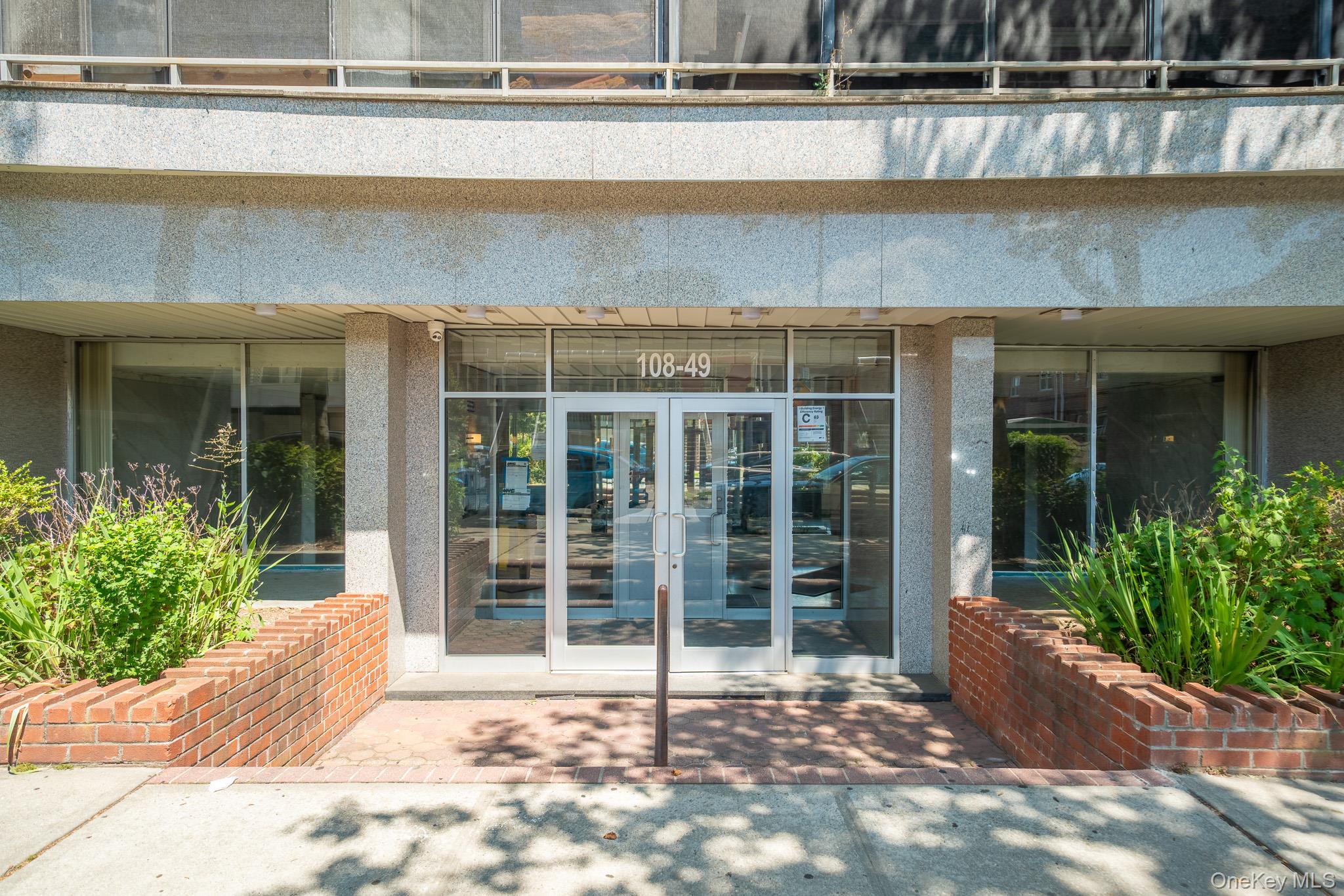 108-49 63rd Avenue, Unit 4A Queens, NY 11375 - Photo 2 of 10 a view of a entrance door of the house with a yard