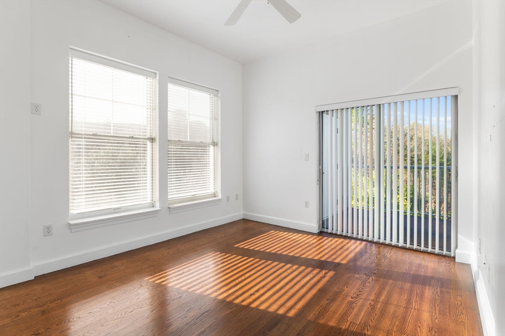 36 Village Road, Unit 715 Middleton, MA 01949 - Photo 12 of 32 a view of an empty room with wooden floor and a window