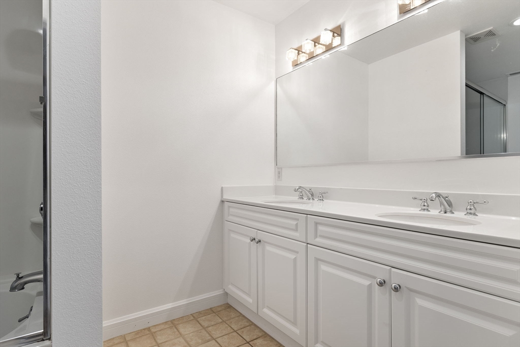 36 Village Road, Unit 715 Middleton, MA 01949 - Photo 17 of 32 a bathroom with a sink and a mirror