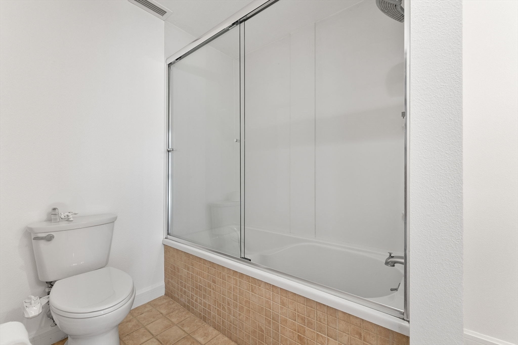 36 Village Road, Unit 715 Middleton, MA 01949 - Photo 19 of 32 a white toilet sitting next to a bath tub