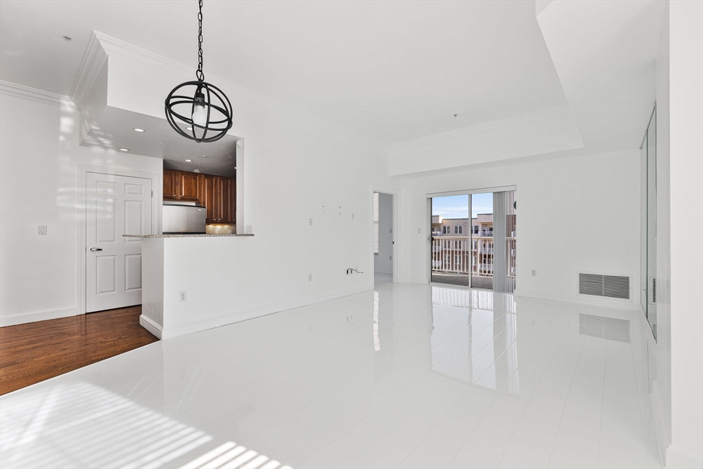 36 Village Road, Unit 715 Middleton, MA 01949 - Photo 3 of 32 a view of an empty room with wooden floor and windows