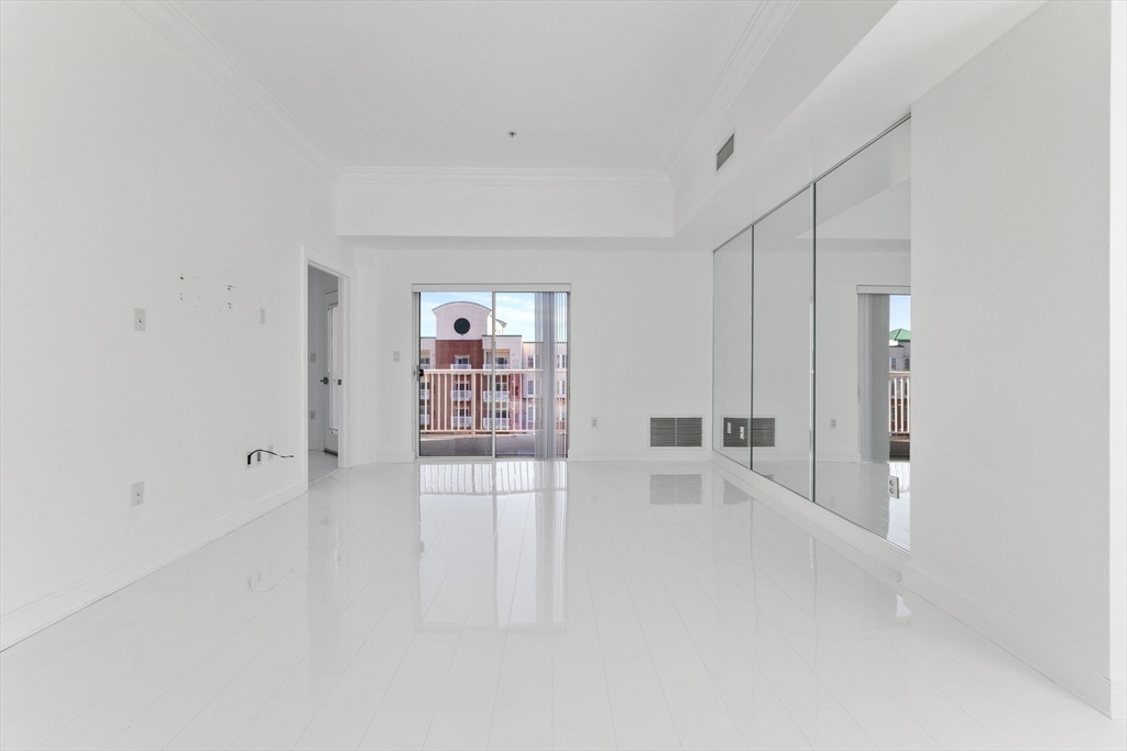 36 Village Road, Unit 715 Middleton, MA 01949 - Photo 4 of 32 an empty room with shelves