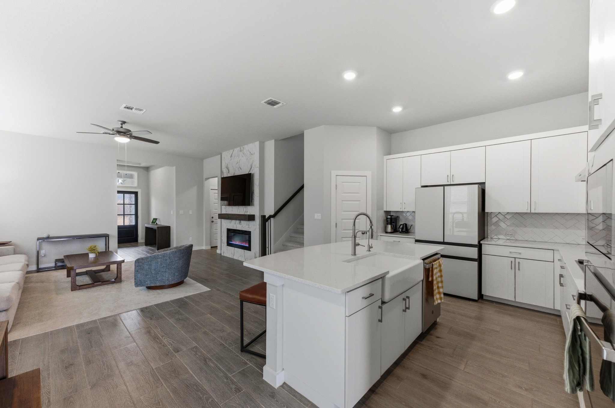 1209 Bluewood Bend Leander, TX 78641 - Photo 11 of 40 a large white kitchen with stainless steel appliances granite countertop a lot of counter space and wooden floor
