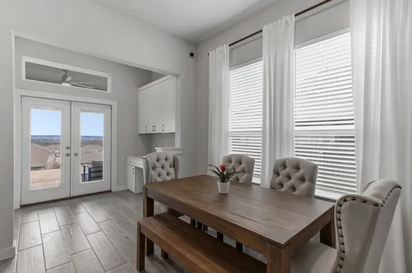 a dining room with furniture and window