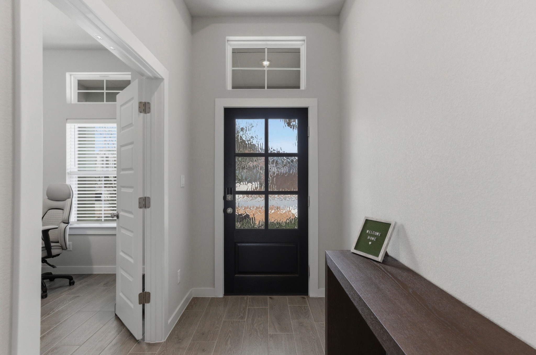 1209 Bluewood Bend Leander, TX 78641 - Photo 14 of 40 a view of a hallway with bathroom and wooden floor