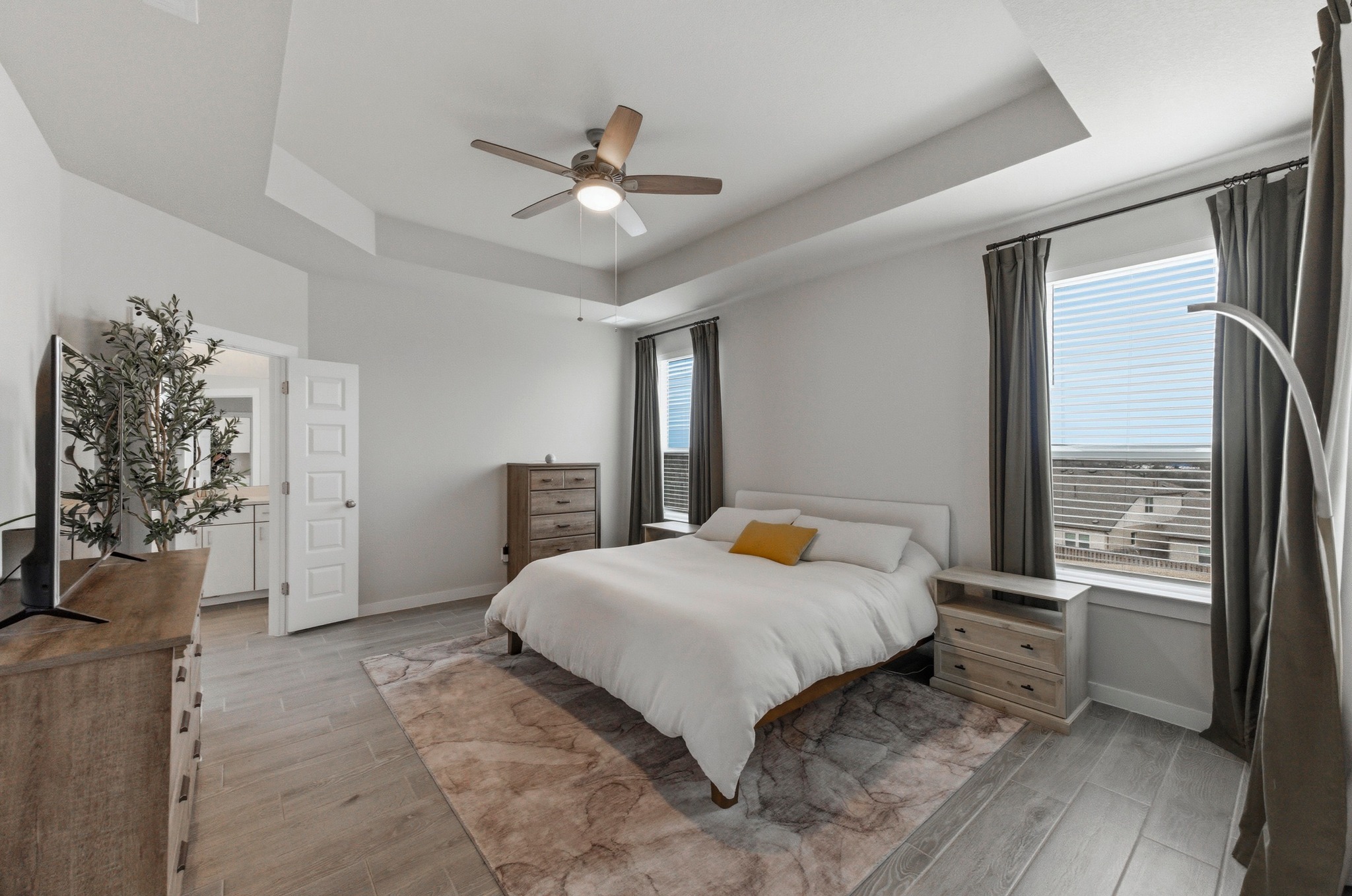 1209 Bluewood Bend Leander, TX 78641 - Photo 16 of 40 a bedroom with a large bed and a chandelier