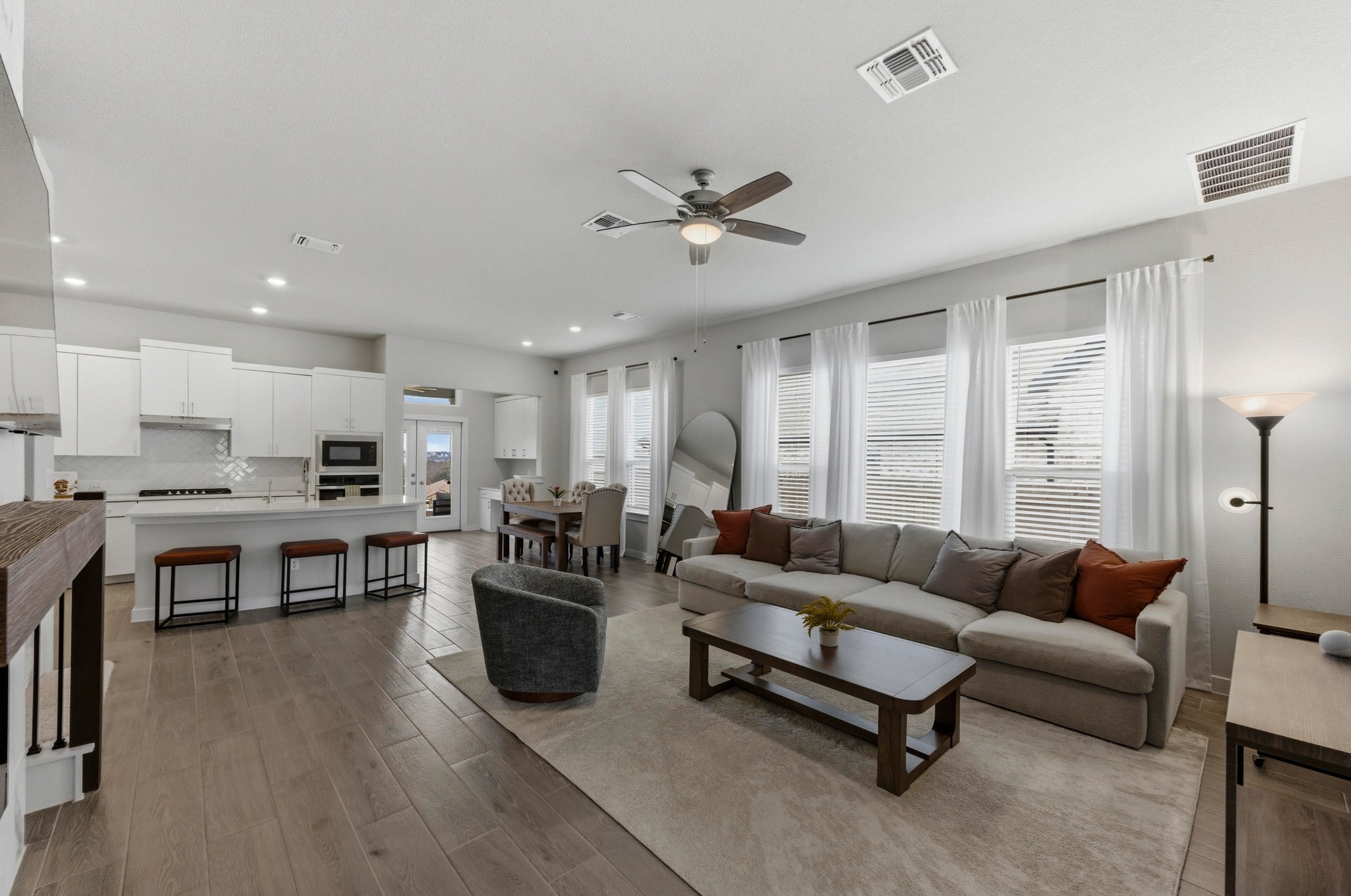 1209 Bluewood Bend Leander, TX 78641 - Photo 4 of 40 a living room with furniture kitchen view and a large window