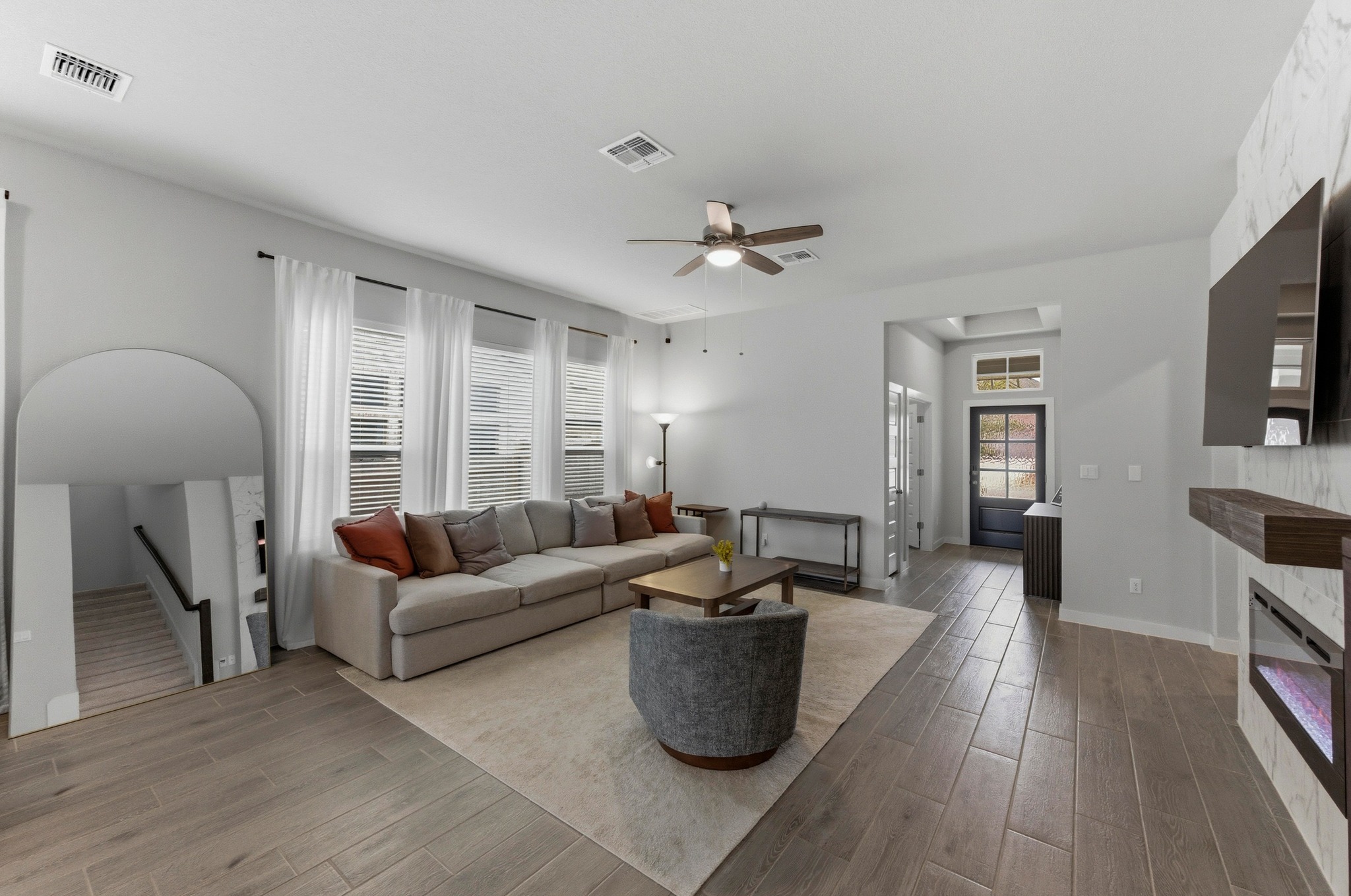 1209 Bluewood Bend Leander, TX 78641 - Photo 5 of 40 a living room with furniture a fireplace and a flat screen tv