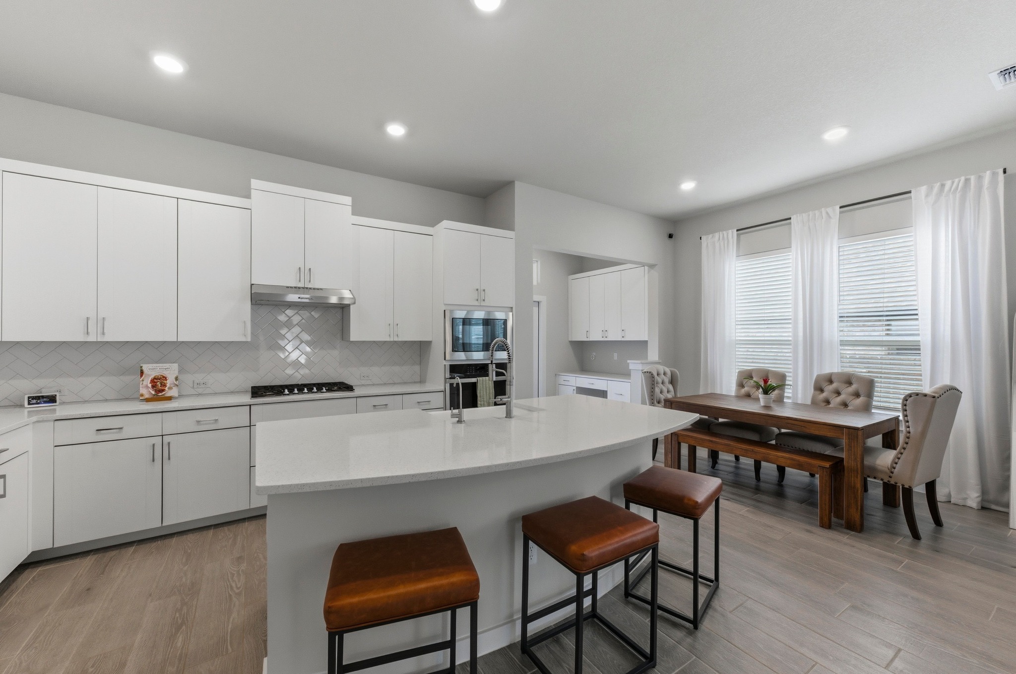1209 Bluewood Bend Leander, TX 78641 - Photo 9 of 40 a kitchen with stainless steel appliances a table and chairs in it