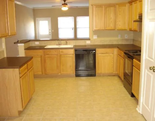 a kitchen with stainless steel appliances granite countertop a sink stove and cabinets