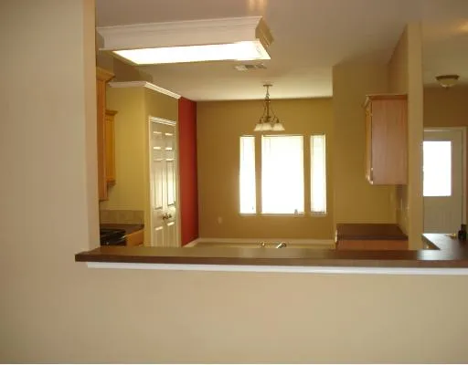 a view of a bathroom with a granite countertop sink and a mirror